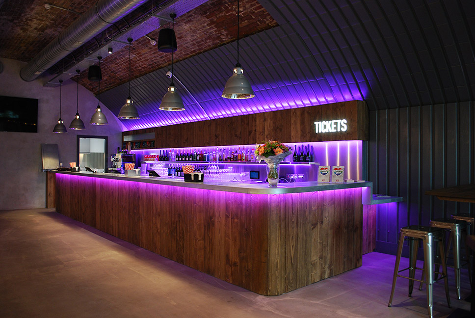 Above The Stag Theatre image of a bar with purple lighting