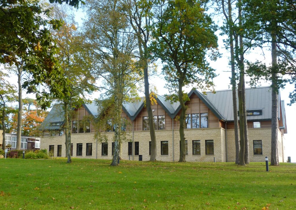 External view of trees in front of the new Kingham Hill School Maths Science Building
