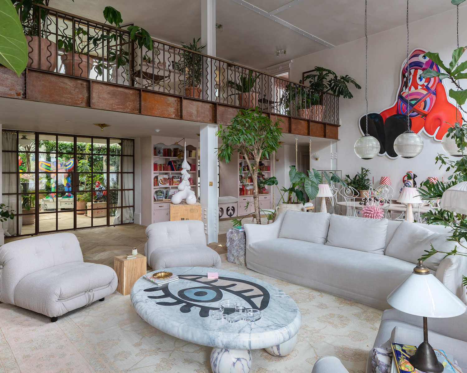 Internal view of a living room with couches and lamps at Chris Dyson Architects designed Maison Colbert, a home, studio, and art gallery in Spitalfields, London.